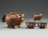 A Chinese yixing 'fruit and nut' teapot, a 'fruit and nut' cup and a pair of enamelled yixing cups