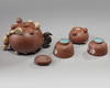 A Chinese yixing 'fruit and nut' teapot, a 'fruit and nut' cup and a pair of enamelled yixing cups