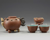 A Chinese yixing 'fruit and nut' teapot, a 'fruit and nut' cup and a pair of enamelled yixing cups
