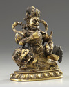 A Sino-Tibetan gilt bronze figure of Jambhala