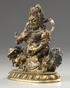 A Sino-Tibetan gilt bronze figure of Jambhala