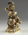 A Sino-Tibetan gilt bronze figure of Jambhala