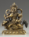 A Sino-Tibetan gilt bronze figure of Jambhala