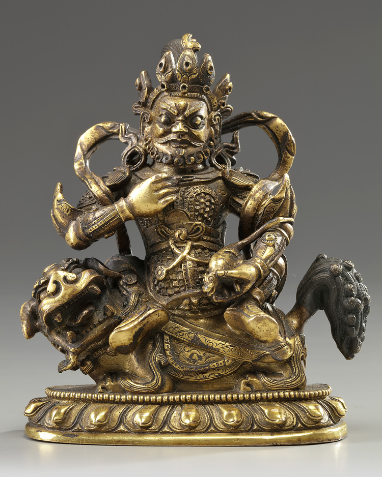 A Sino-Tibetan gilt bronze figure of Jambhala