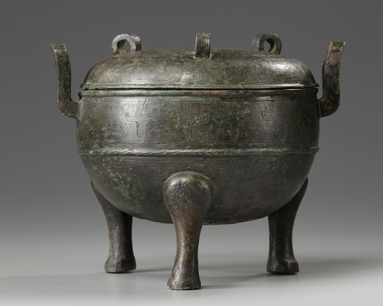 A Chinese bronze tripod ding and cover