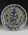 A massive Chinese yellow-glazed blue and white dragon charger