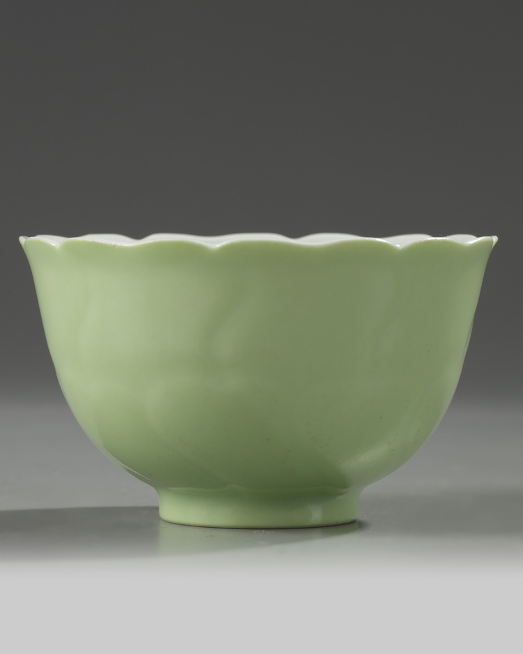 A Chinese pale-green glazed moulded 'floral' bowl