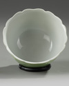 A Chinese pale-green glazed moulded 'floral' bowl