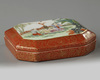A Chinese coral-ground famille rose octagonal seal paste box and cover