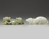 A Chinese white agate dog carving and a celadon jade twin dog carving