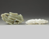 A Chinese white agate dog carving and a celadon jade twin dog carving