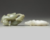A Chinese white agate dog carving and a celadon jade twin dog carving