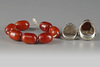 Two silver rings and an amber bracelet
