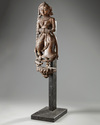An Indian wood sculpture of a lady on a marble stand