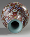 A Chinese red-ground famille rose bottle vase