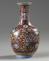 A Chinese red-ground famille rose bottle vase