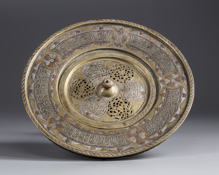 An Islamic silver inlaid brass hand wash bowl