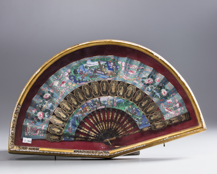 A Chinese Cantonese silk and paper fan with black lacquer guardsticks