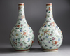 A pair of Chinese famille rose celadon-ground slip-decorated bottle vases