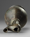 An Islamic bronze oil lamp