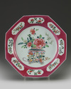 A Chinese ruby-ground famille-rose 'flower basket' octagonal dish