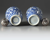 A pair of silver-mounted Chinese blue and white ovoid vases and covers