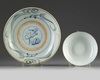 A Chinese Zhangzhou Swatow blue and white charger and a famille rose bowl