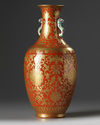 A Chinese coral-ground gilt-decorated slender vase