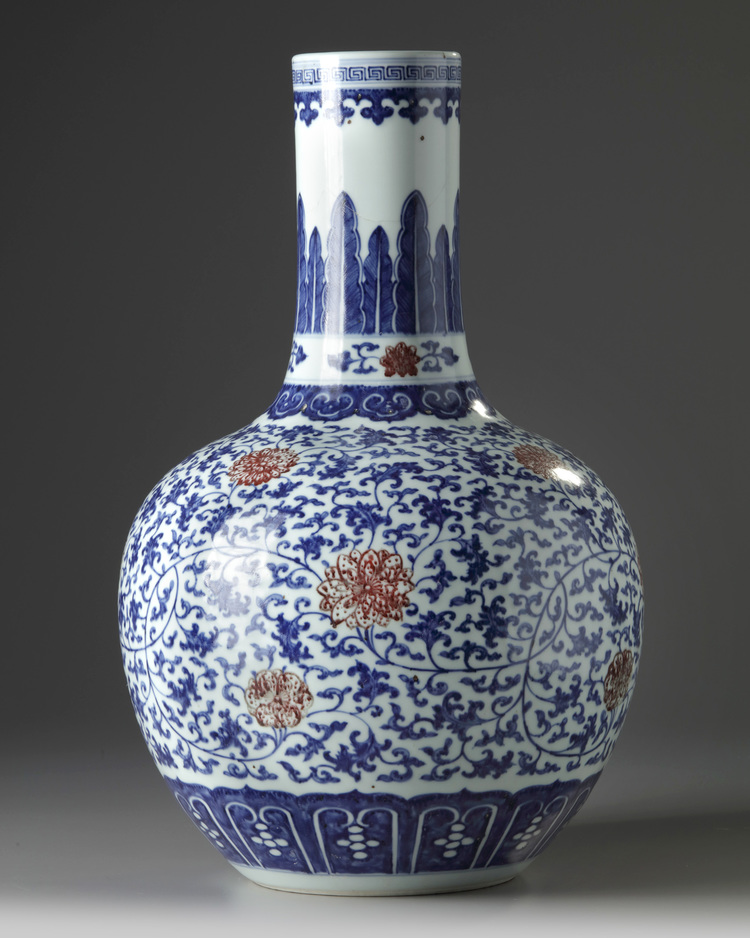 A Chinese blue and white and underglaze copper red-decorated ‘flower scroll’ bottle vase