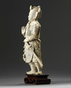 A large Chinese carved ivory figure of a guardian