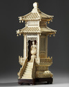 A carved ivory monk in a large ivory shrine. The Shrine is Chinese, the monk Japanese.