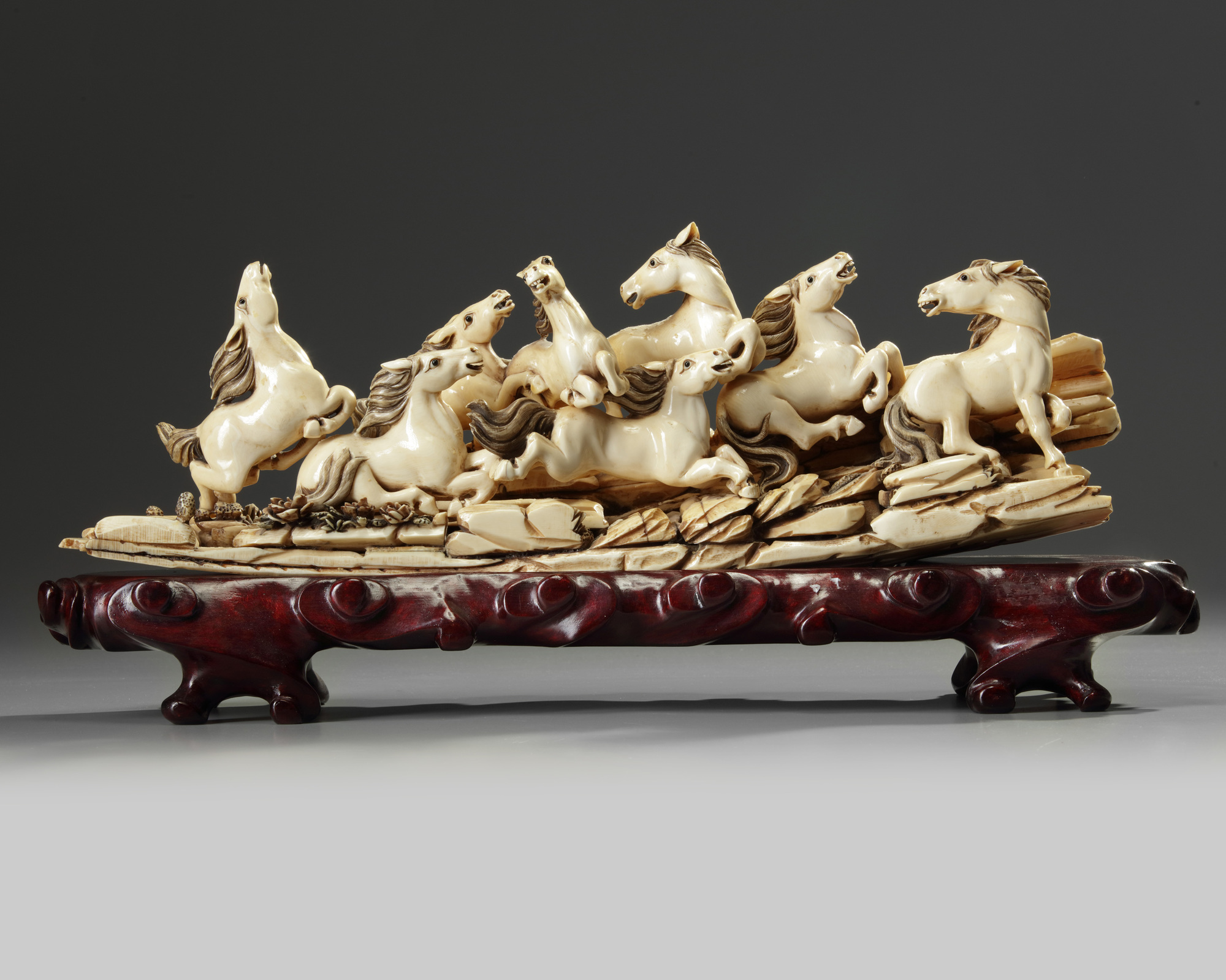 A Chinese carved ivory 'Eight Horses of Mu Wang' group