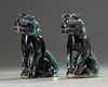 A pair aubergine and turquoise decorated Buddhist lions