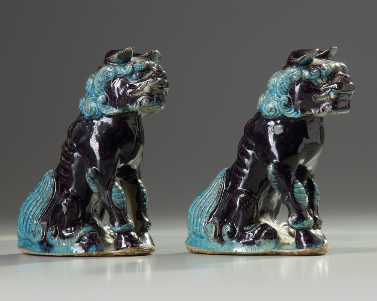 A pair aubergine and turquoise decorated Buddhist lions