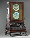 A Chinese gilt bronze clock in a hongmu case and stand