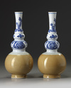 A pair of Chinese café-au-lait-glazed blue and white triple gourd vases