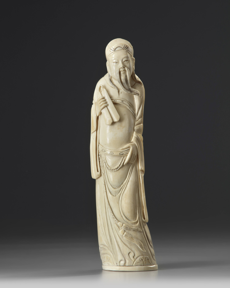 A Chinese carved ivory scholar