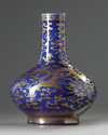 A Chinese blue-ground gilt-decorated 'dragon and phoenix' bottle vase