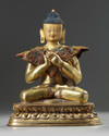 A Tibetan gilt bronze figure of Maitreya