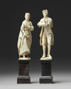 A pair of European 'Dieppe' figs on wooden stands