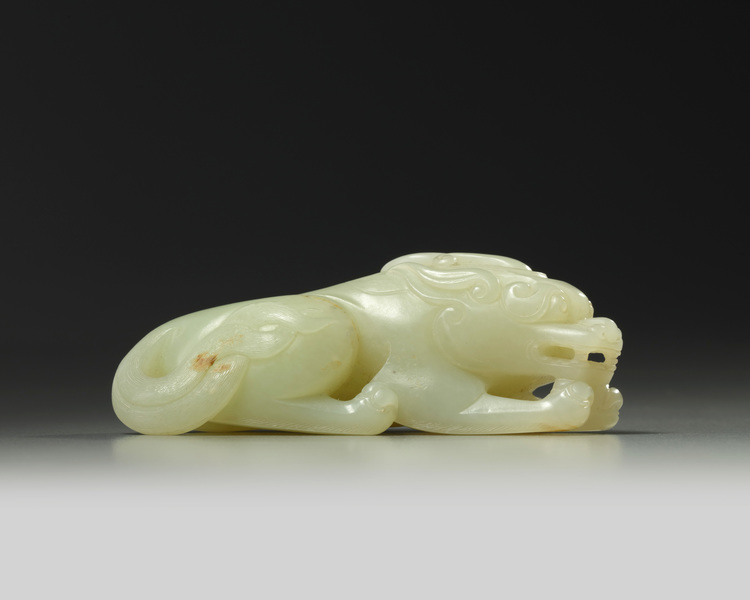 A Chinese pale celadon jade recumbent qilin