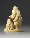 A Japanese ivory okimono of two figures and a frog
