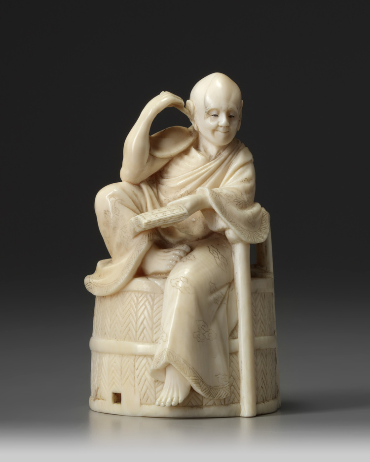 A JAPANESE OKIMONO OF A SEATED MAN