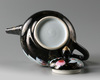 A Chinese mirror black-ground famille rose 'quails' teapot and cover