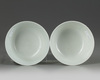 A pair of Chinese green glazed 'dragon' bowls