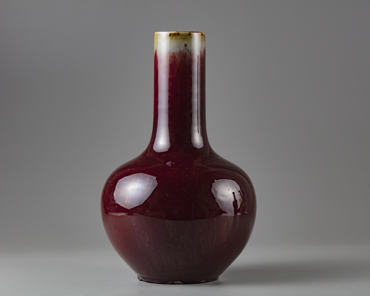 A red glazed bottle vase