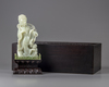 A pale jade carving of a guanyin in a zitan box and stand