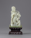 A pale jade carving of a guanyin in a zitan box and stand