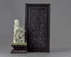 A pale jade carving of a guanyin in a zitan box and stand