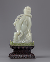 A pale jade carving of a guanyin in a zitan box and stand